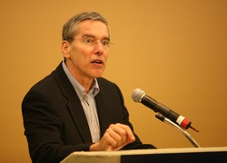 the Rev. Stephen Hayner speaks at a podium