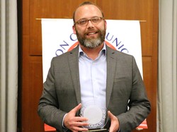 David Barnhart receives the DeRose-Hinkhouse Best in Class “Audio & Video, Broadcast, Non-Broadcast, and Cable” Award the Presbyterian Disaster Assistance documentary, 'Locked in a Box: Immigration Detention.'