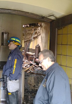 Investigators survey the damage inside First Presbyterian Church of Englewood, New Jersey, the day after the March 22, 2016 fire caused extensive damage.