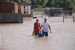 A couple leaves their home following flooding in Oklahoma.