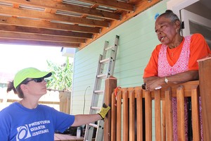 A Presbyterian Disaster Assistance volunteer speaks with Anita Jones as the team puts the finishing touches on Jones' remodeled home.