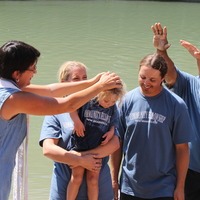 People in water for baptism