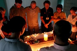 Brett Faucett (center) praying with participants in one of the training courses.