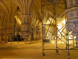 The sanctuary  of First and Franklin Presbyterian Church under construction, in yellow  lighting.