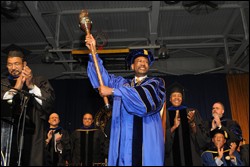 Dr. Ronald Lee Carter accepts the University scepter as a symbol of his installation as president.