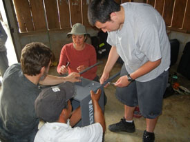 A group of people assembling a stove in a Guatemalan home.