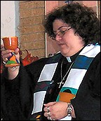 Marissa Galvan-Valle in vestments holding a chalice
