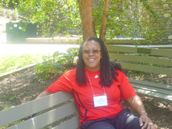 The Rev. Flo Watkins sitting on a bench.