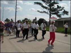 The Treme Brass Band leads volunteers and denomination representatives through the Little Woods neighborhood in New Orleans.