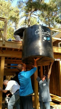 Installing a water collection tank at Clean Water U.