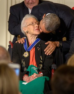 President Barack Obama kisses former NASA mathematician Katherine Johnson after presenting her with the Presidential Medal of Freedom, Tuesday, Nov. 24, 2015.