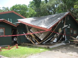 Exterior of the damaged dining hall at John Knox Ranch.