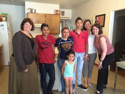 Laurie Kraus (left) and Susan Krehbiel (right) with Presbyterian Disaster Assistance, meet with a family from Guatamala who are staying at a welcome home after release from a family detention center in Karnes, Texas.