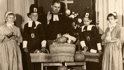 Donated food is blessed before being distributed. Sunday school children dressed as Puritans look on ― circa 1950.
