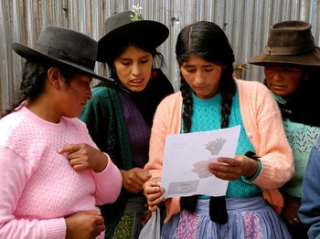 Artisans from the group Tupac Yupanki, which is supported by Partners for Just Trade, review an order. 