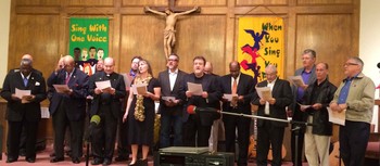 group of clergy lead congregation in song