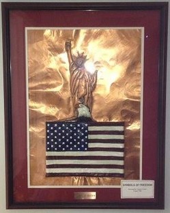 “Symbols of Freedom," bas relief on copper by Clyde Carter.