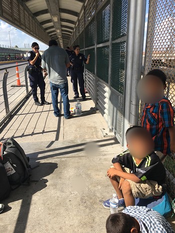 Asylum-seeking family stopped pedestrian bridge in Mexico by U.S. Customs and Border Patrol - Summer 2018