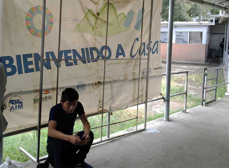 Deportee waits for assistance after being processed in a Guatemalan military facility