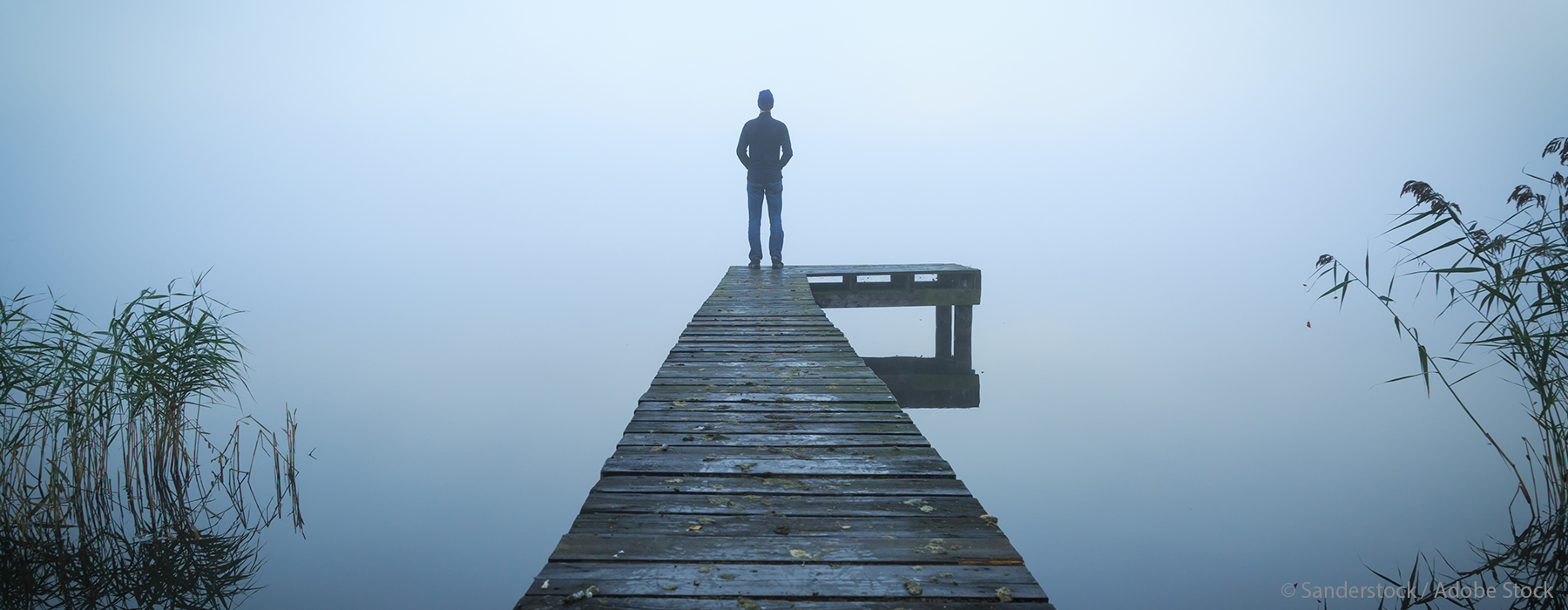Image of man standing on pier