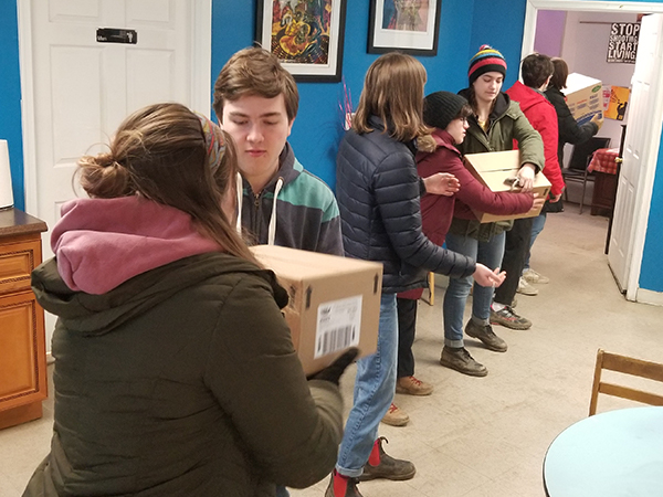 Youth from State College Presbyterian Church move boxes of food at Amazing Grace Lutheran Church in Baltimore during a recent mission trip. Photo provided.