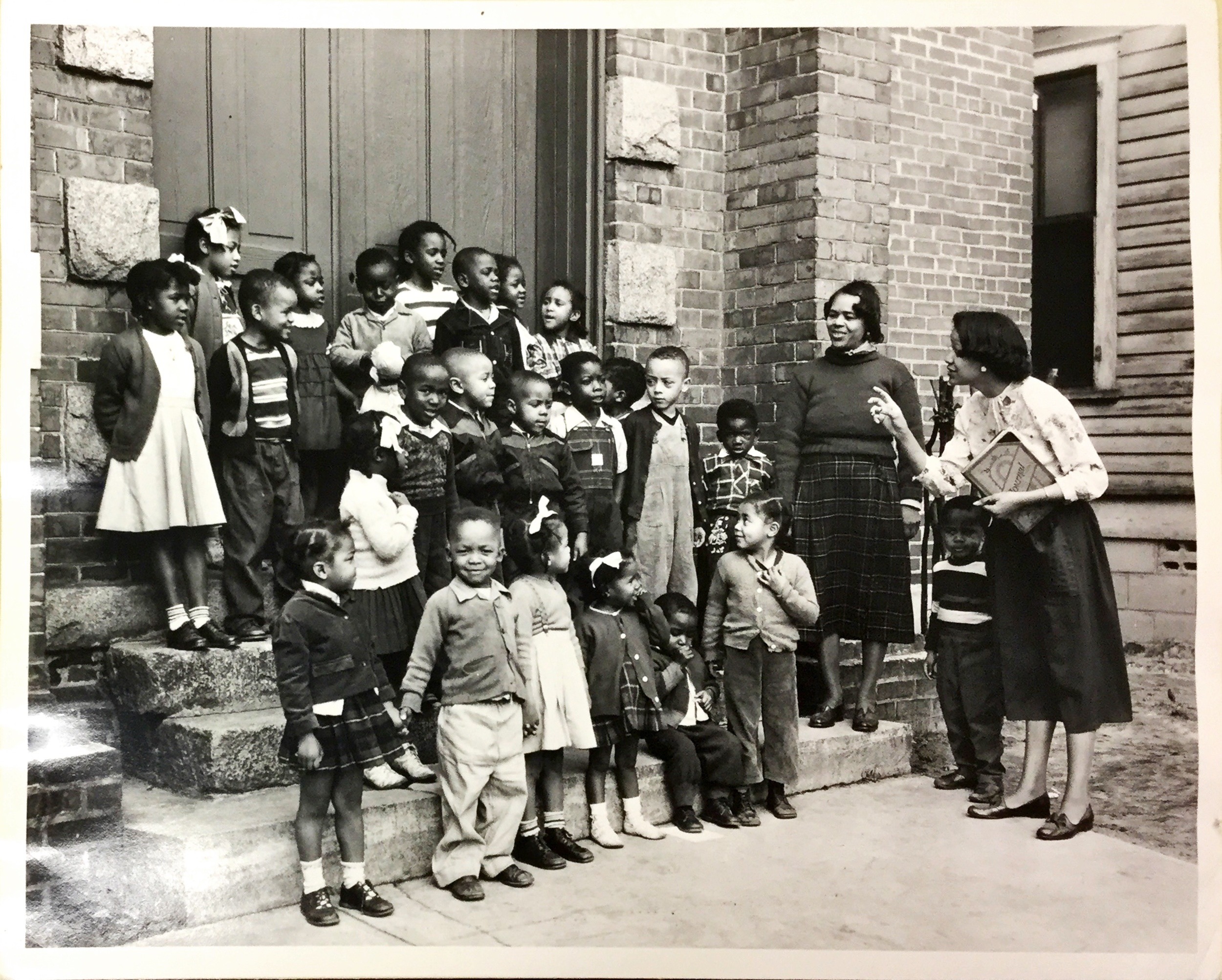 Mrs. Emily Ivory (widow of Cecil A. Ivory, superintendent of the nursery, leads the children of Hermon United Presbyterian Church in Rock Hill, S.C., in song. Cecil Ivory served the Hermon Church from 1949-1961, From congregational vertical file, RG425.