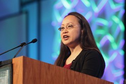 Jihyun Oh, moderator of Committee 7, Ecumenical and Interfaith Relations, addresses plenary during the 221st General Assembly (2014) of the PC(USA) in Detroit, MI on Thursday, June 19, 2014. 