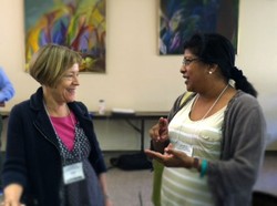 Heidi Hadsell (left), president and professor of social ethics of Hartford Seminary; talks with Damayanthi Niles, professor of constructive theology and acting dean at Eden Theological Seminary.