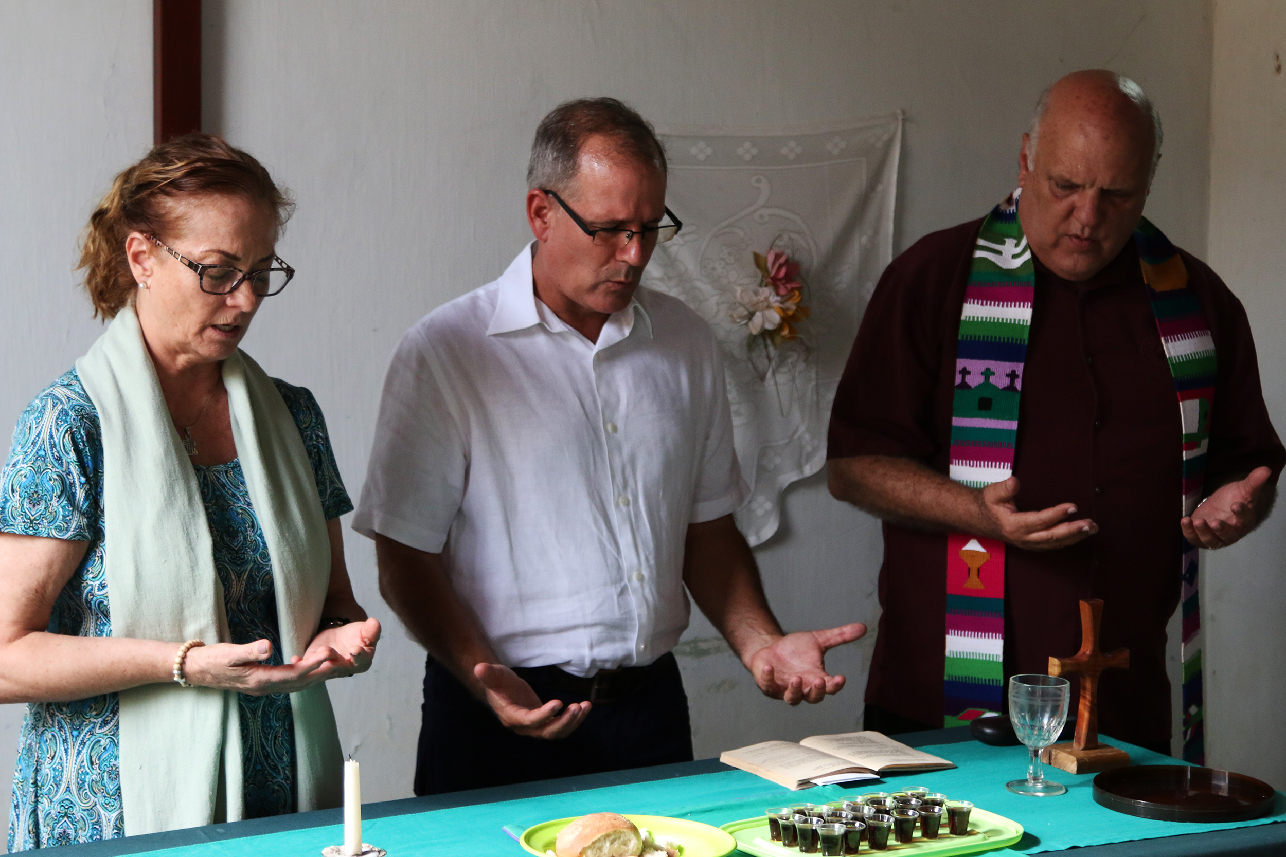 Jo Ella Holman (left), Ary Fernandez (center) and Edelberto Valdes (right) officiate for the Sacrament of the Lord’s Supper at Camagüey Mission.