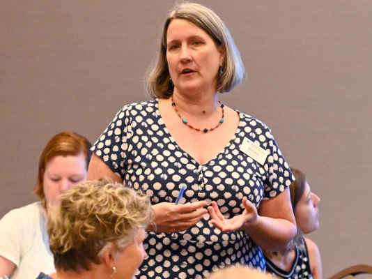 Susan Krehbiel, catalyst for refugees and asylum with Presbyterian Disaster Assistance, speaks during Thursday’s Big Tent workshop. (Photo by Rich Copley)