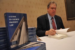 Photo of Attorney Lloyd Lunceford with his books
