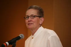 a woman speaks at a podium