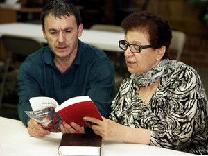 Saeed Bakr and Nahrim Shamoon share a prayer book during a Monday night Bible study in Arabic, at Middle Eastern Presbyterian Fellowship.