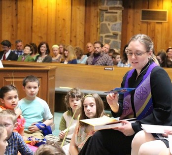 Chudy shares "fish boxes" story and the One Great Hour of Sharing with children on Palm Sunday.