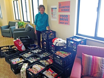 Janie Cearley Robinson, member of Wellshire Presbyterian Church in Denver, stands with some of the good collected for the Souper Bowl of Caring.