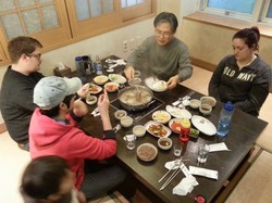 Elder Dae Tan Moon of Seongnae Church dines with two Young Adult Volunteers and YAV Korea coordinator Hyeyoung Lee following their visit to Peace Park. 