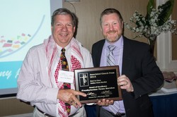 Retired Presbyterian News Service editor Jerry Van Marter receives the Associated Church Press Best In Class award for online new service from current Presbyterian News Service editor and Associated Church Press past-president Gregg Brekke.