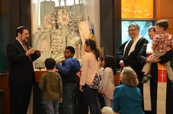Rabbi Jordan Millstein (left) shows the Torah scrolls to children during a joint worship service between Temple Sinai and First Presbyterian Church of Englewood, New Jersey. First Presbyterian Pastor Richard Hong and the Rev. Kellie Anderson-Picallo stand to the right. 
