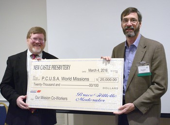 New Castle Presbytery moderator, Bruce Gillette, presents Hunter Farrell, director of Presbyterian World Mission, with a check for $20,000.