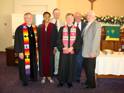 A group of church leaders standing with their vestments on.