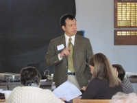Eric Law speaking before a class of students.