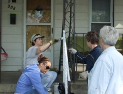 People painting a railing