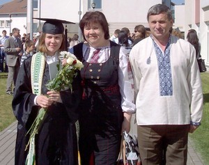 Iryna Sychyk with her parents at graduation.