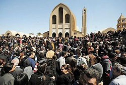 Some of the thousands of Egyptians who gathered to pay respects to Pope Shenouda. Instead of lying in state, his body was seated on a wooden throne. 
