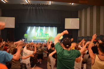 Energizers get the Youth Triennium crowd on their feet during opening worship.