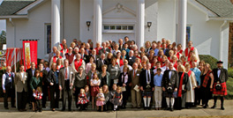 A large group of people standing in front of a church.
