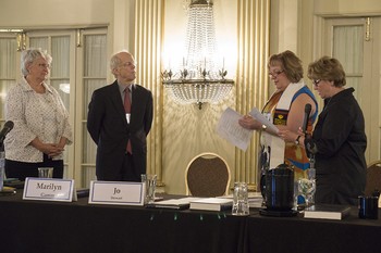Marsha Zell Anson and Ken Godshall are installed as vice-chair and chair of the Presbyterian Mission Agency Board by former chair Marilyn Gamm and former vice-chair Jo Stewart.