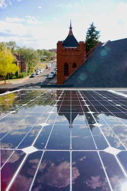 View of solar panels on top of Flagstaff Federated’s gathering hall, overlooking the church’s bell tower.