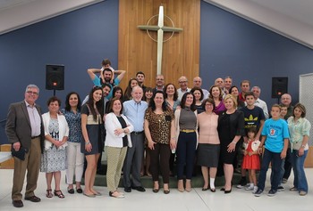 Tim McCalmont (center left) with the Syrian congregation following their Arabic speaking Easter season worship. He says he is grateful to God for ‘dropping what has become a life of its own into his church’s lap.’