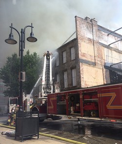 Firefighters battle the July 6 blaze in Louisville’s historic ‘Whiskey Row’ outside the Washington Street entrance to the PC(USA) headquarters.